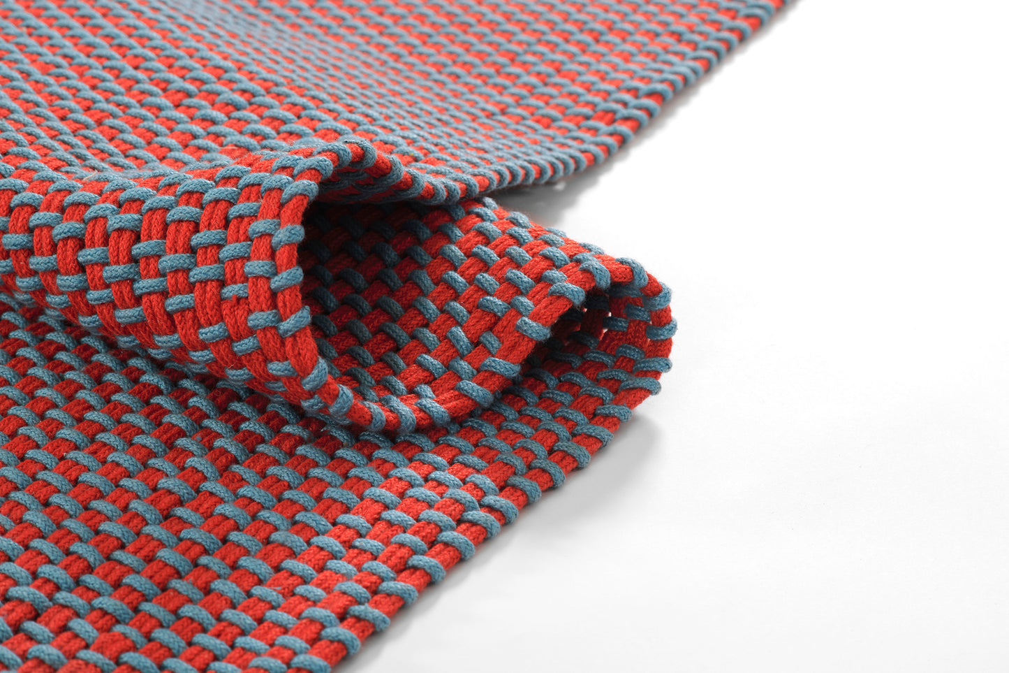 Red and teal braided paracord rug runner with a tight weave and folded edge, 3' x 8'.