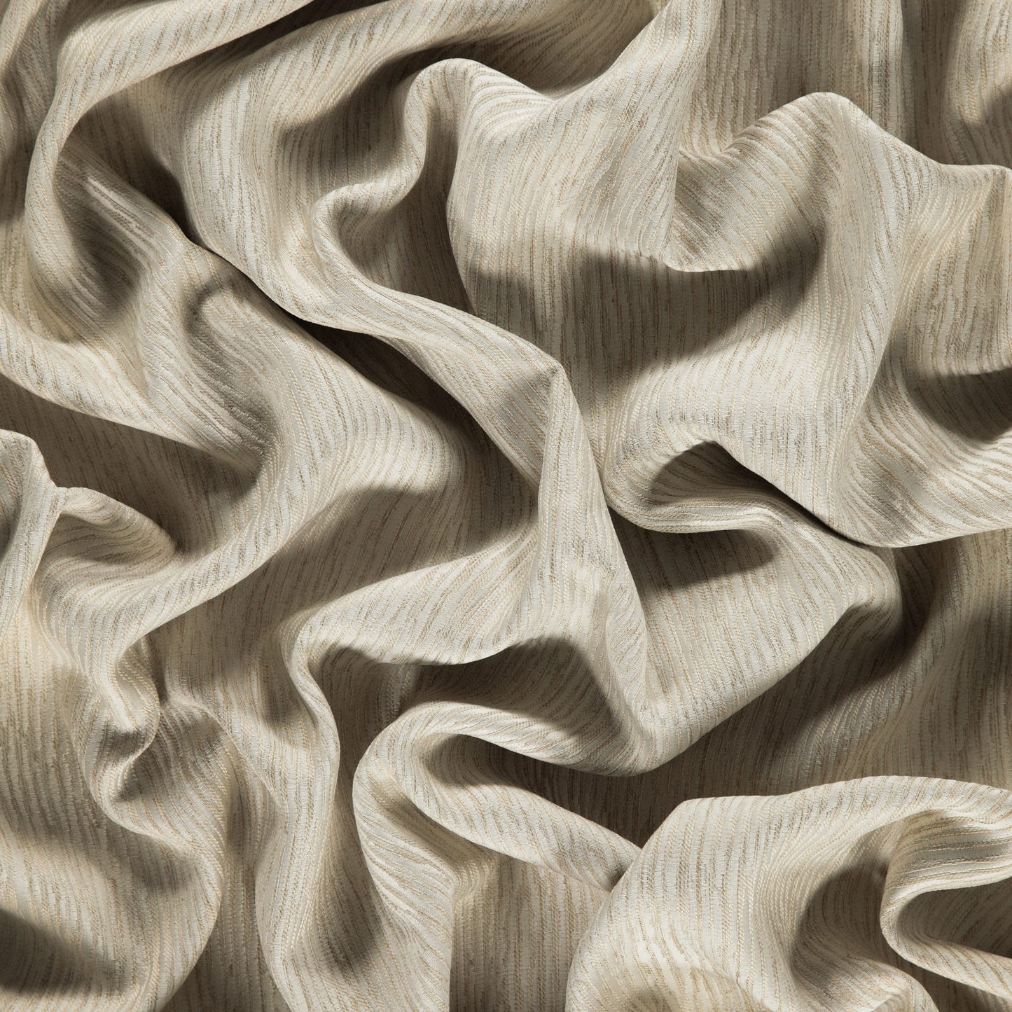 Cream-beige linen-like fabric with subtle vertical stripes, softly draped in flowing folds.