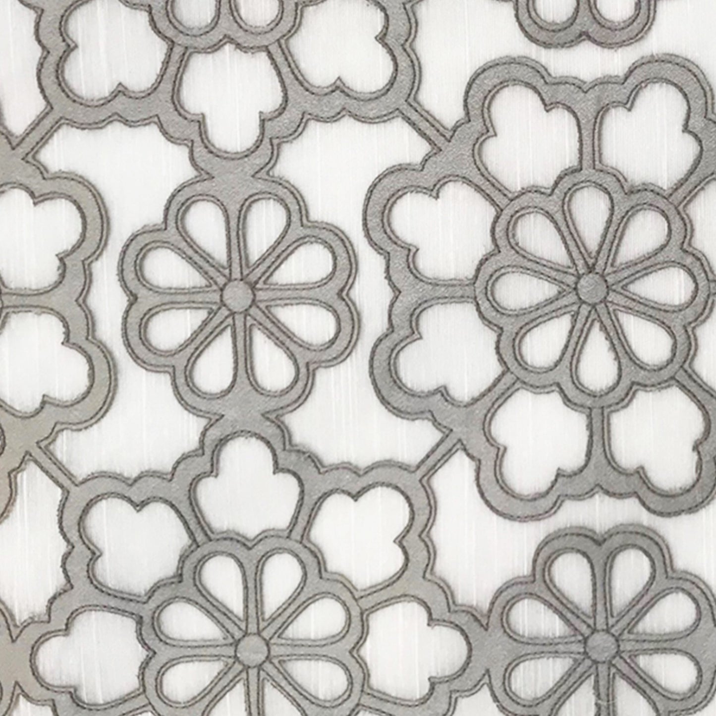 Gray floral quatrefoil embroidery on a light background; elegant fabric for curtains or upholstery