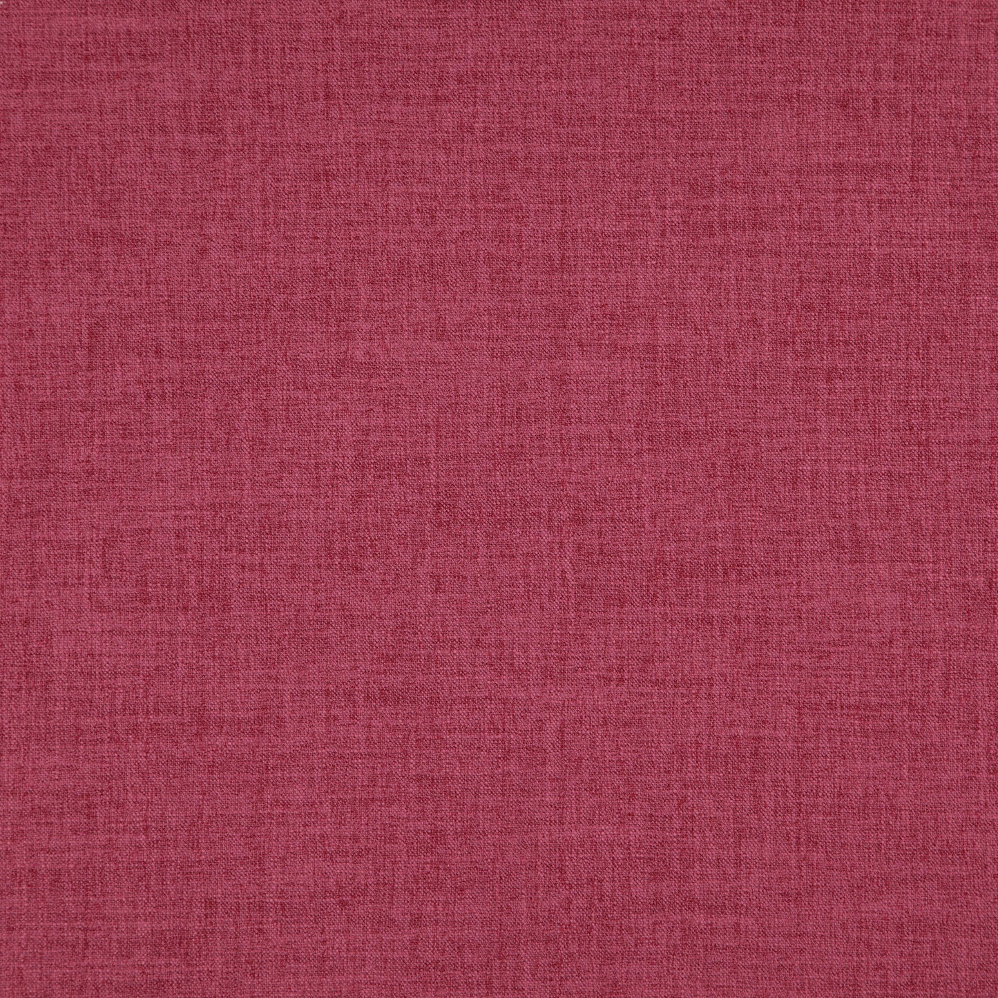 Close-up of pink linen-textured fabric with visible fibers and weave.