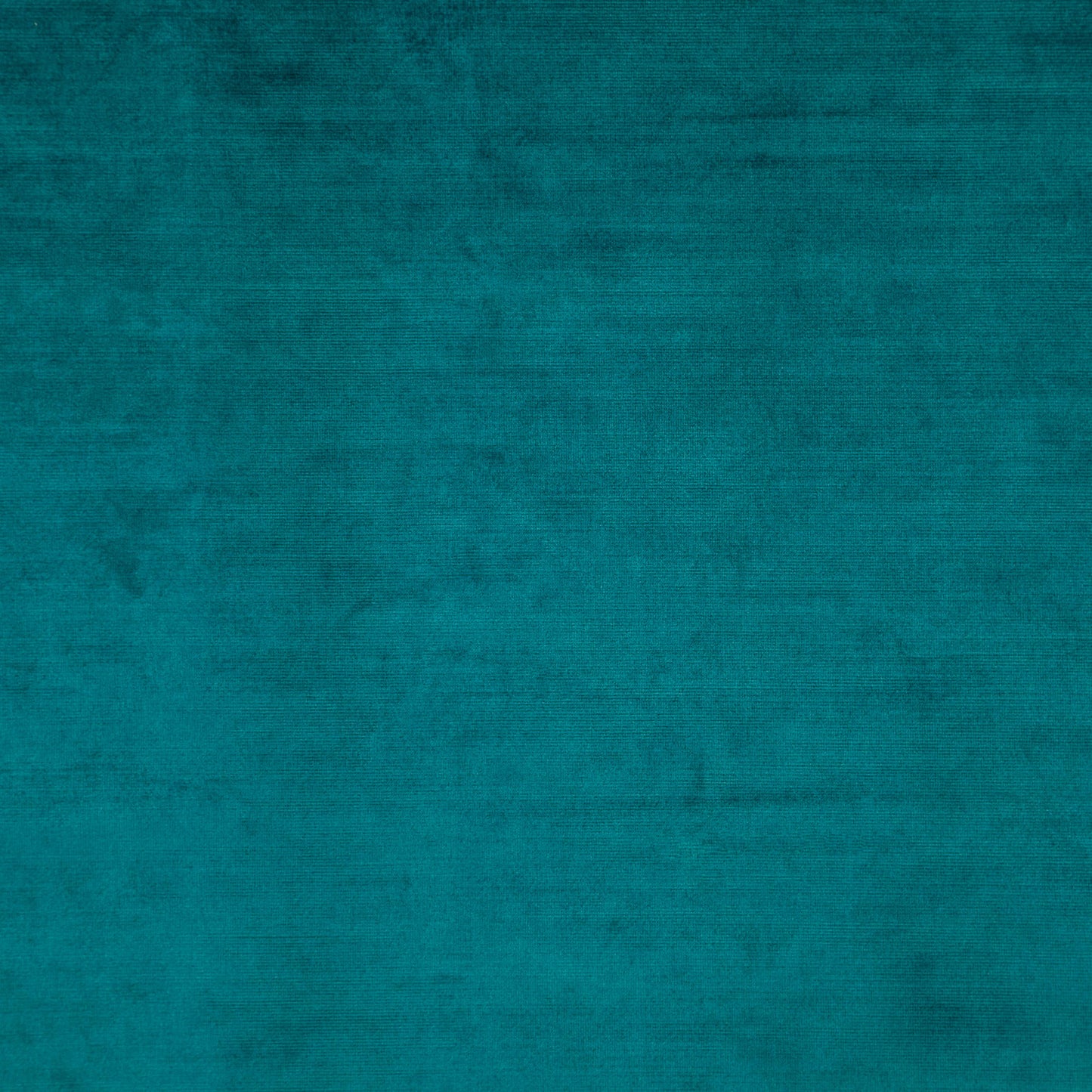 Teal velvet fabric texture with plush nap and subtle mottled shading.