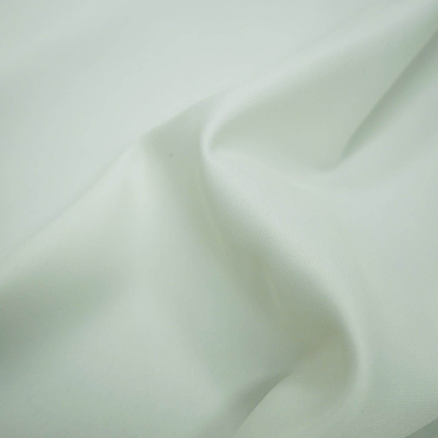 Plain white lining fabric with a smooth drape and gentle folds.
