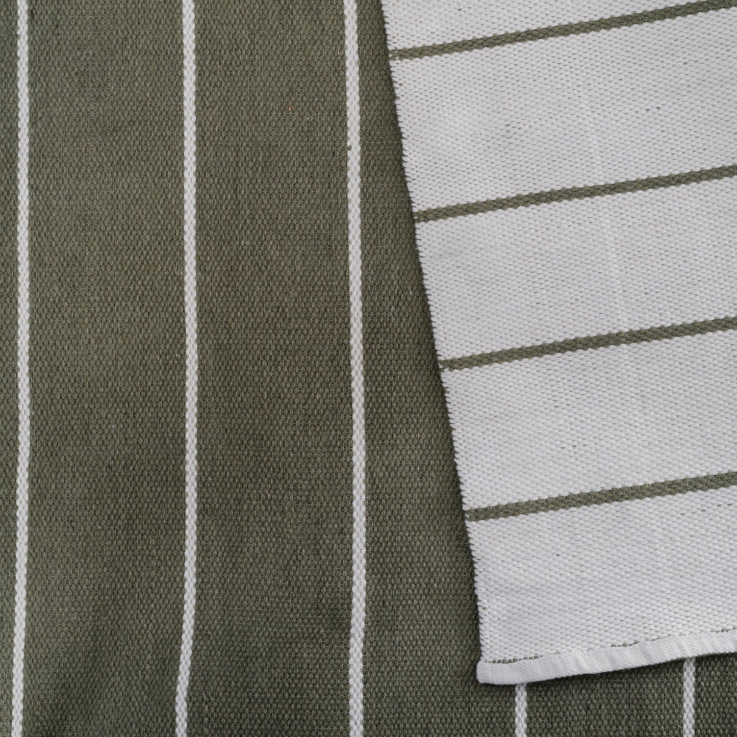 Olive green linen fabric with white vertical stripes, overlapped by light gray fabric with dark green horizontal stripes.
