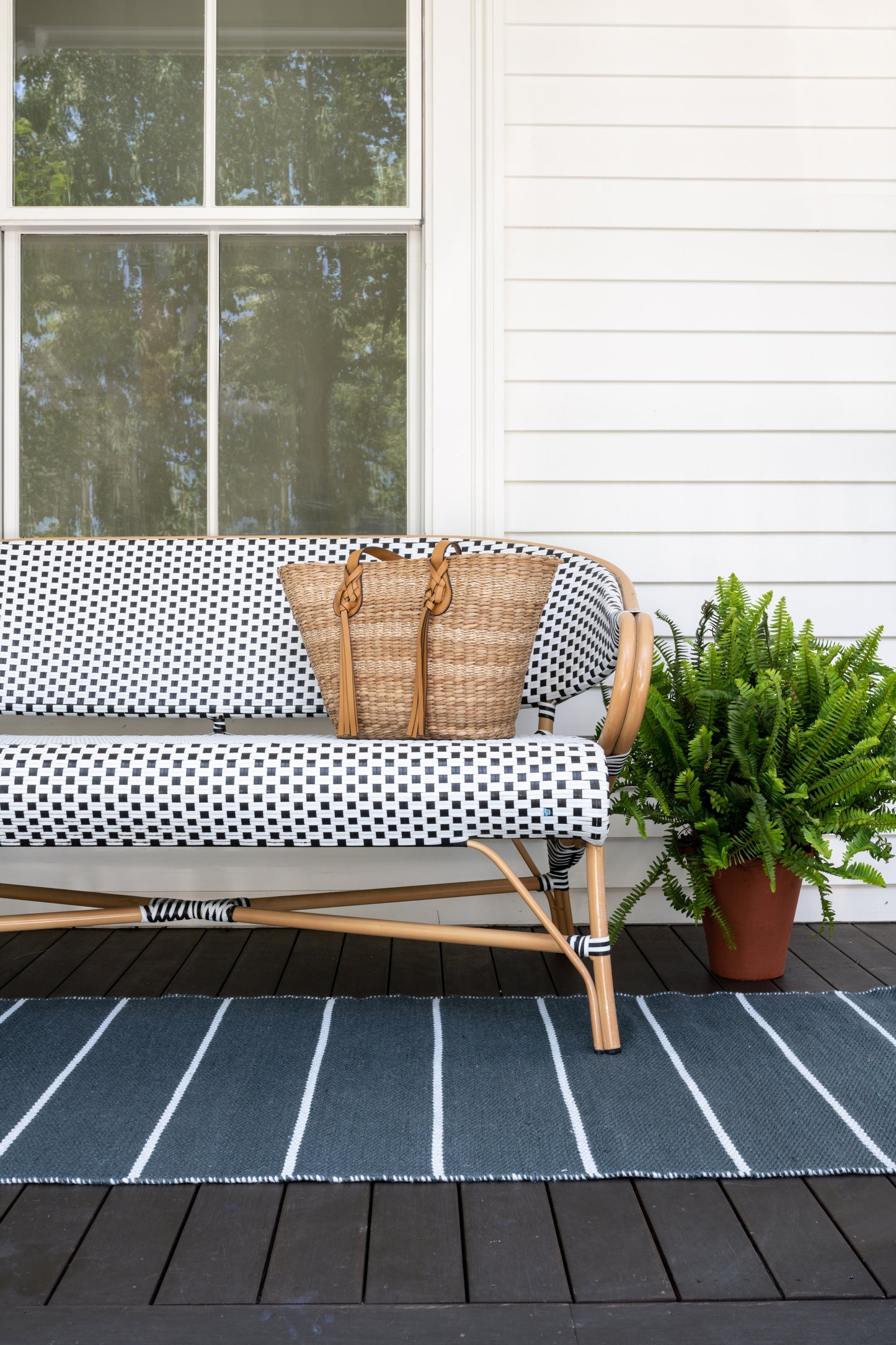 Outdoor 2' x 8' striped rug runner on a wooden porch.