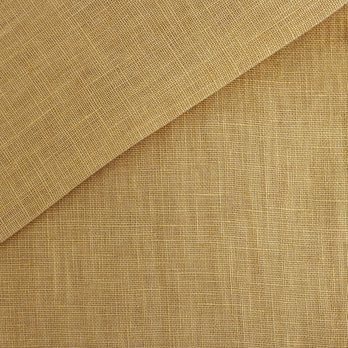 Beige to gold linen texture fabric with a subtle weave, folded corner.