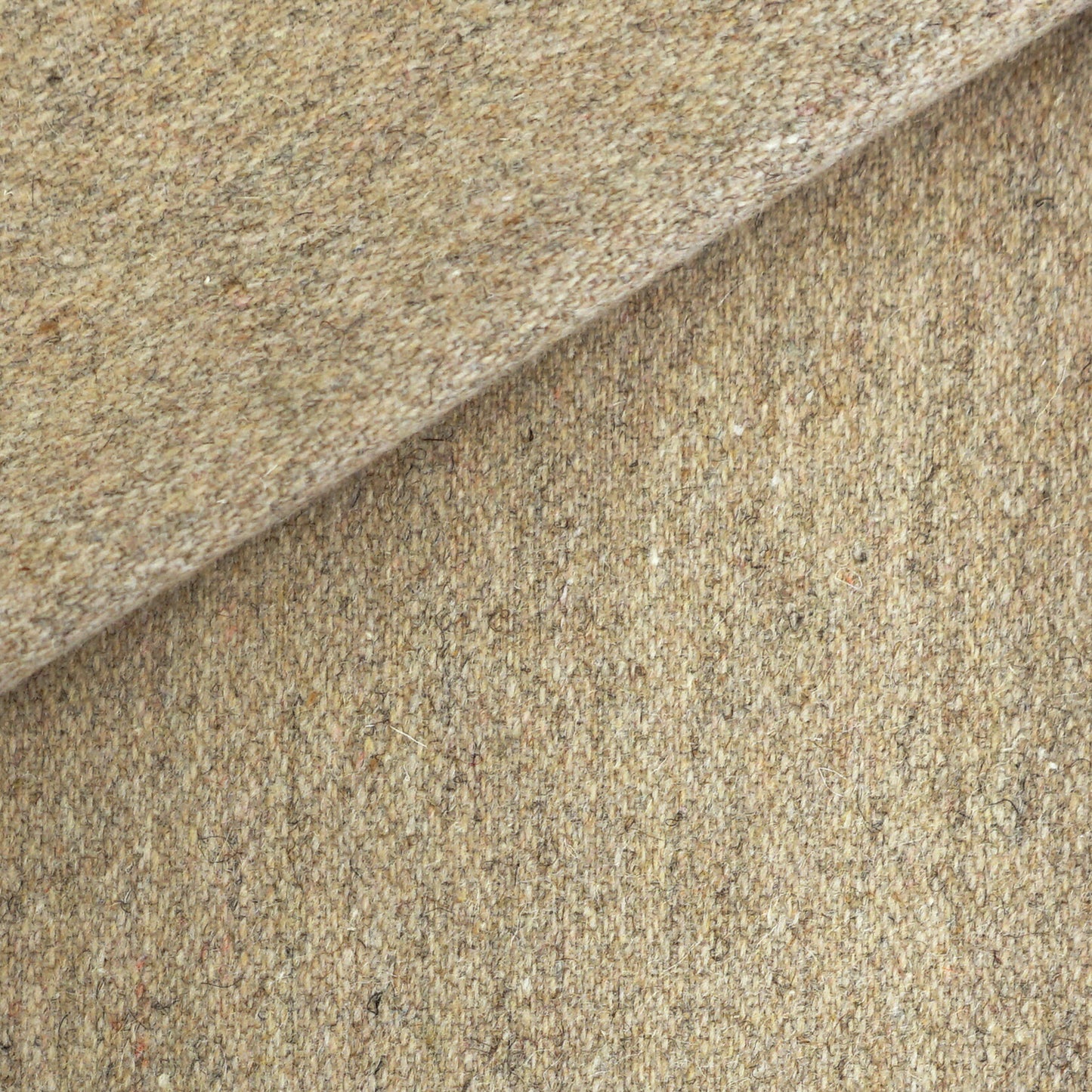 Beige speckled tweed wool fabric, folded to show textured weave; ideal for suits or upholstery.