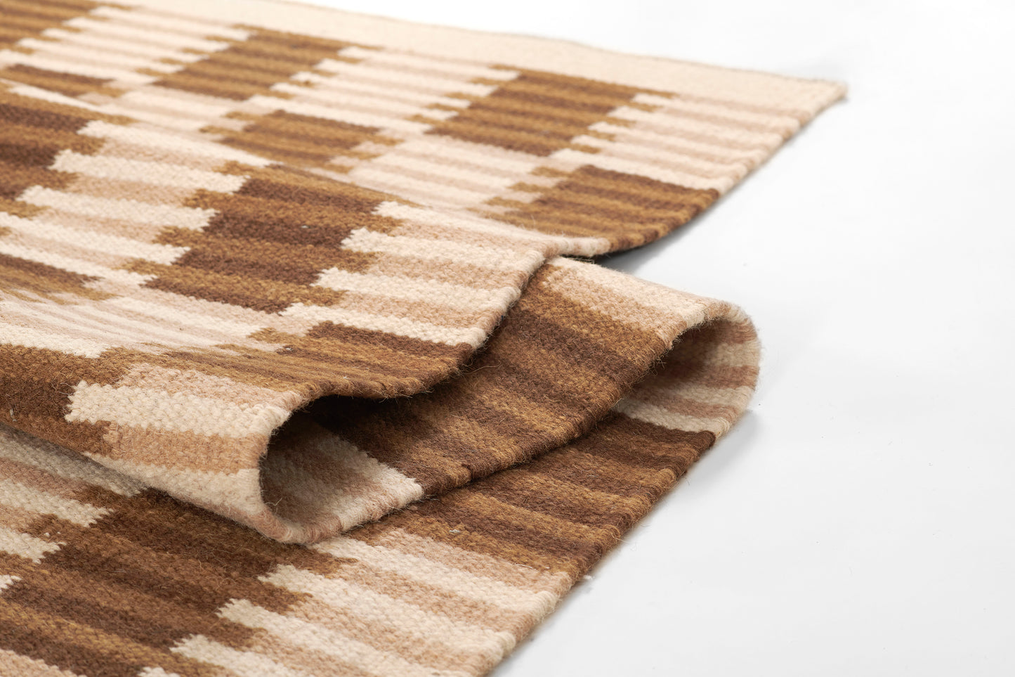 Brown and beige plaid rug, soft woven fabric with folded edge (5' x 8').