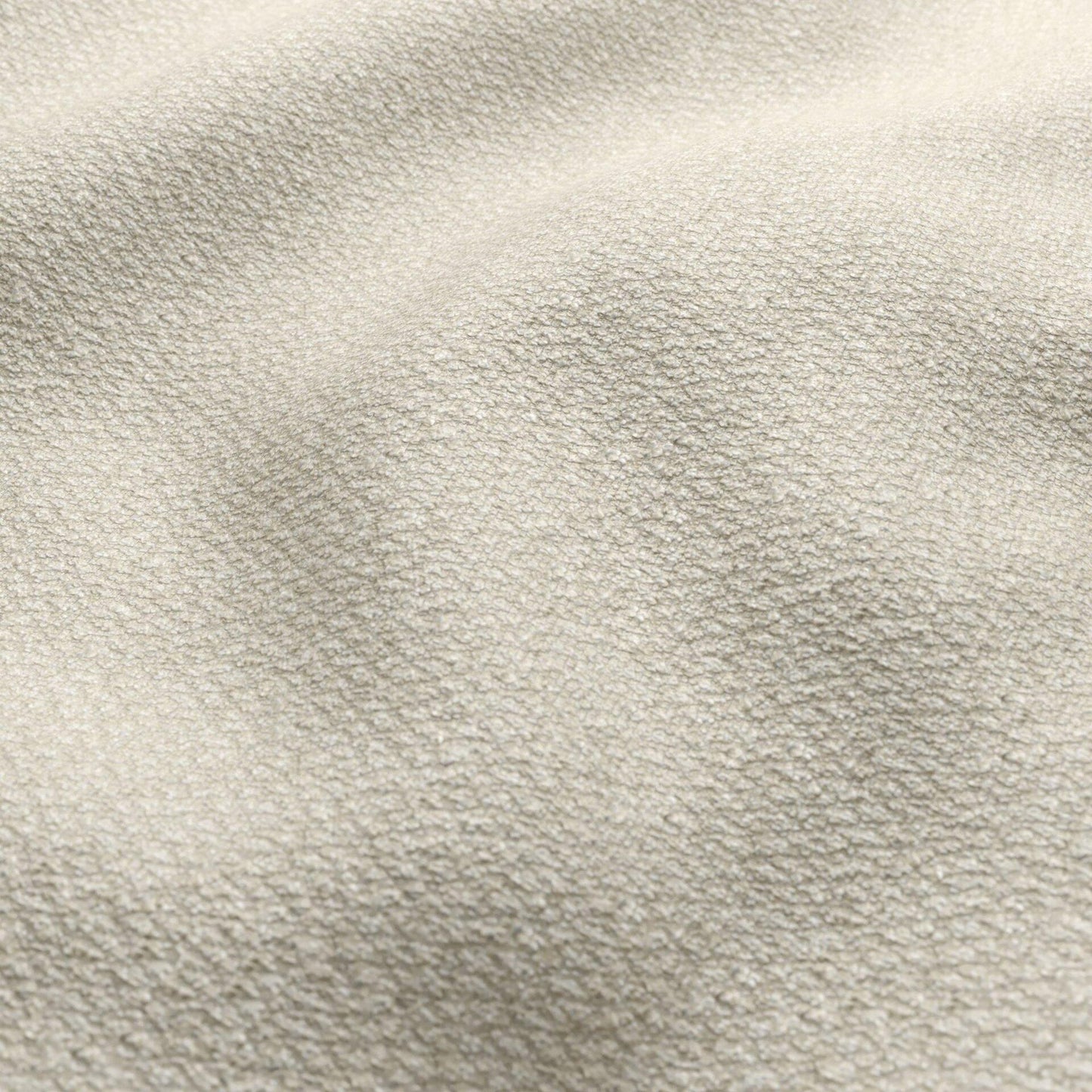Beige and cream boucle fabric close-up with a textured, nubby surface and soft folds.