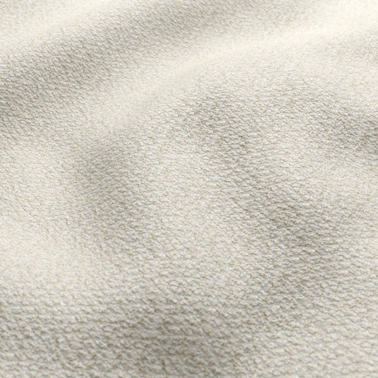 Beige boucle fabric with a textured ivory surface; close-up of textile.
