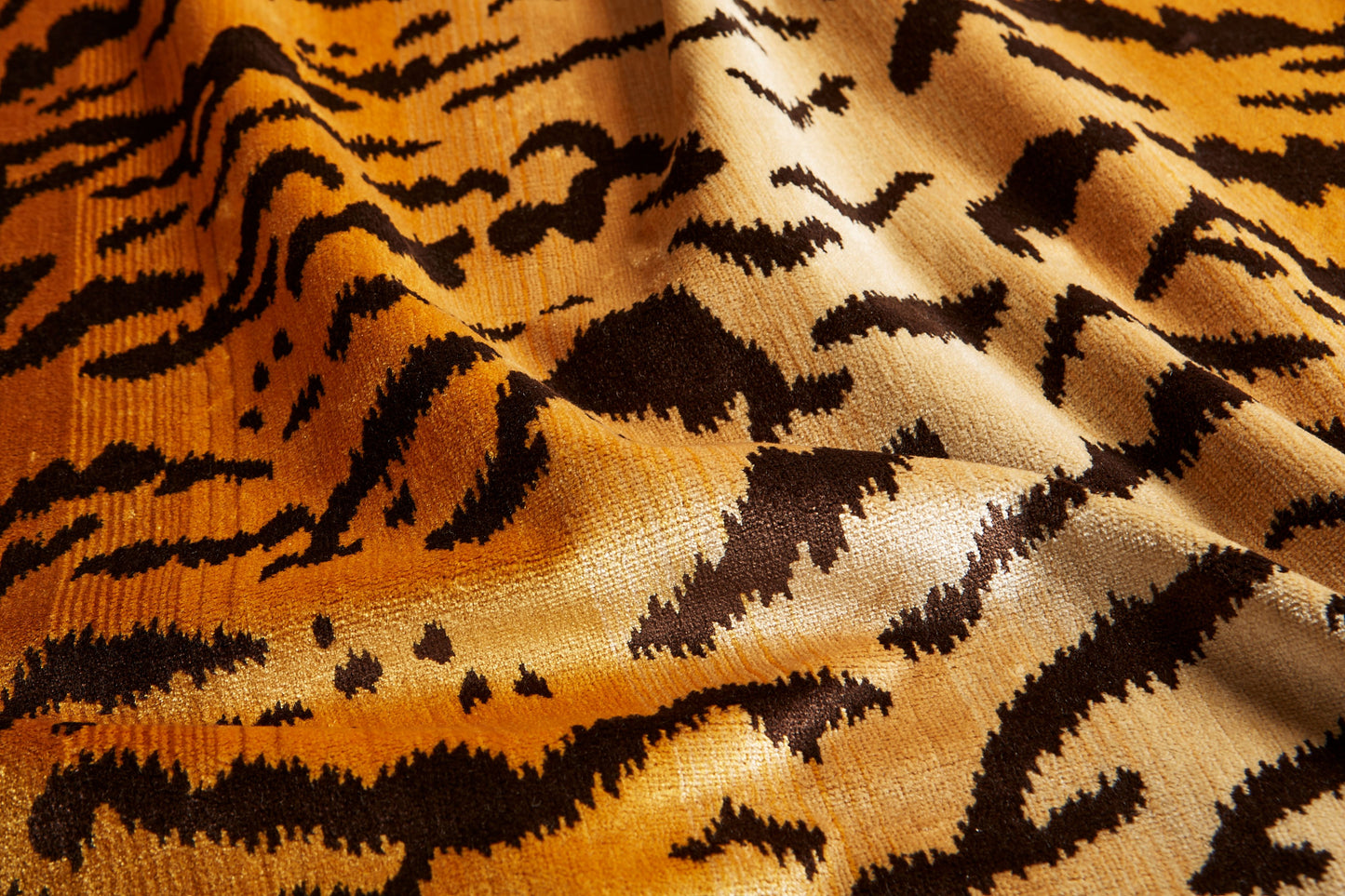 Orange tiger-print fabric with black jagged stripes and soft nap.