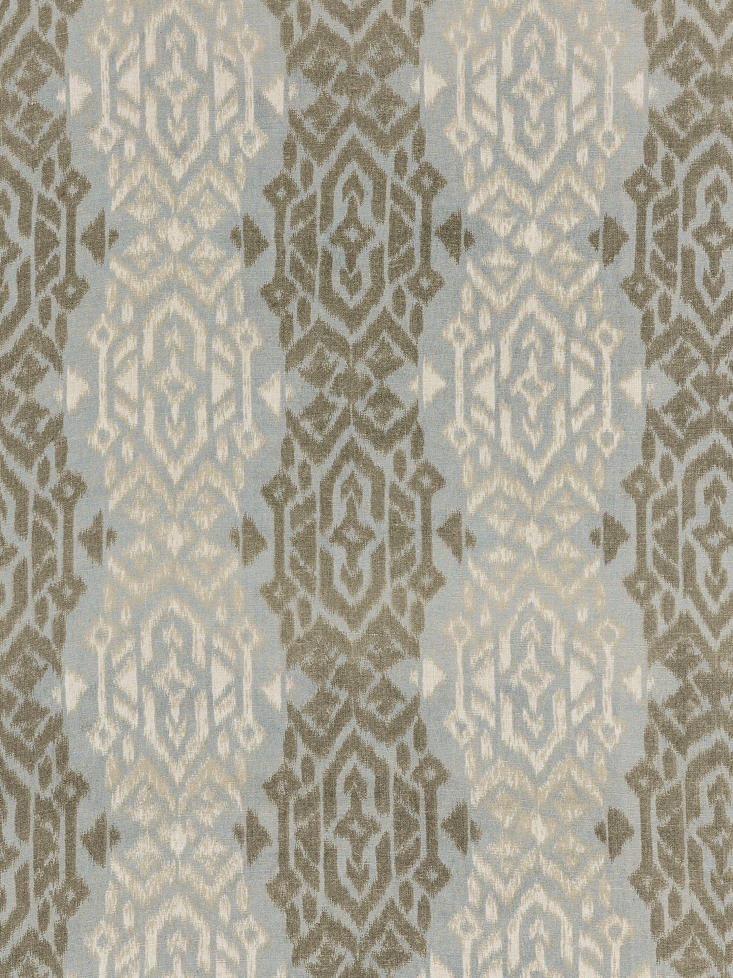 Blue-gray Sumatra ikat weave fabric with taupe and cream ornate medallions in a repeating vertical pattern.