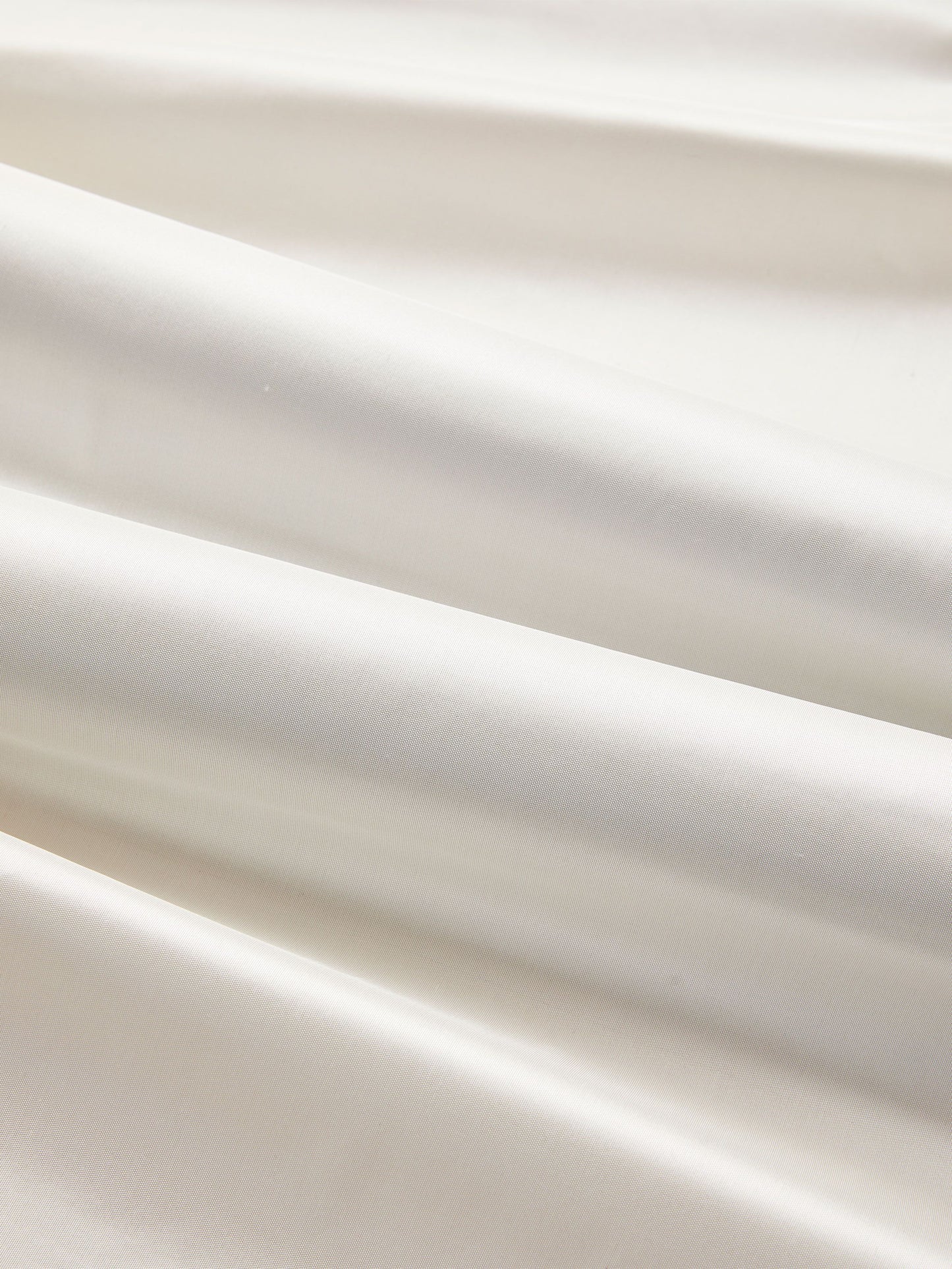 White silk taffeta fabric with luxurious sheen, flowing folds, suitable for dresses, linings, or drapery.
