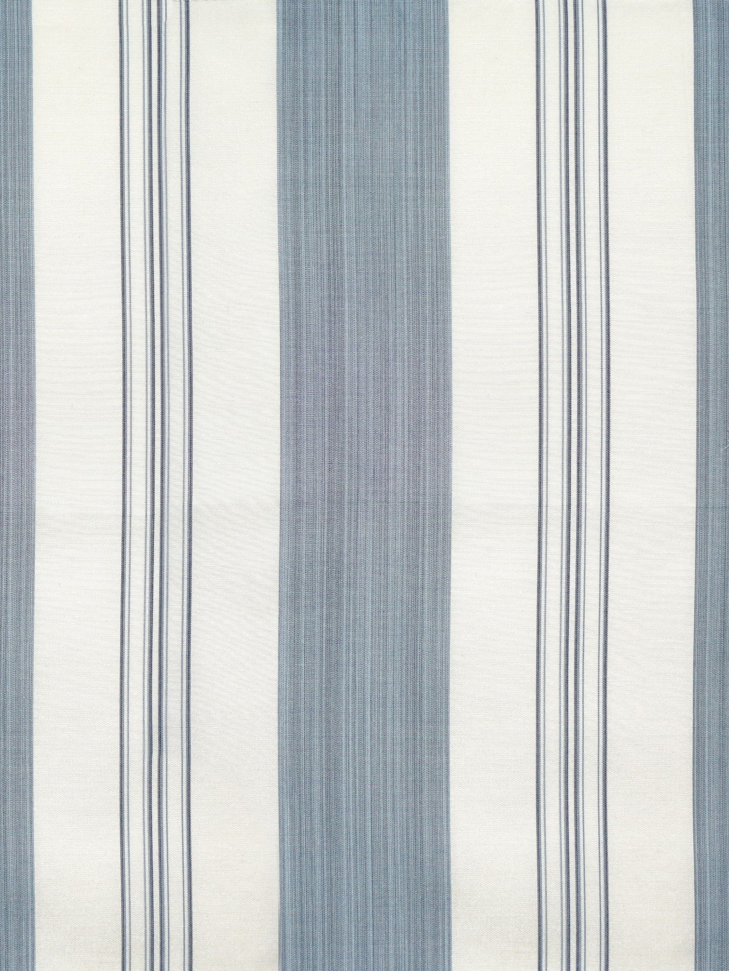 Indigo and ivory striped fabric with wide and narrow vertical stripes and subtle woven texture.