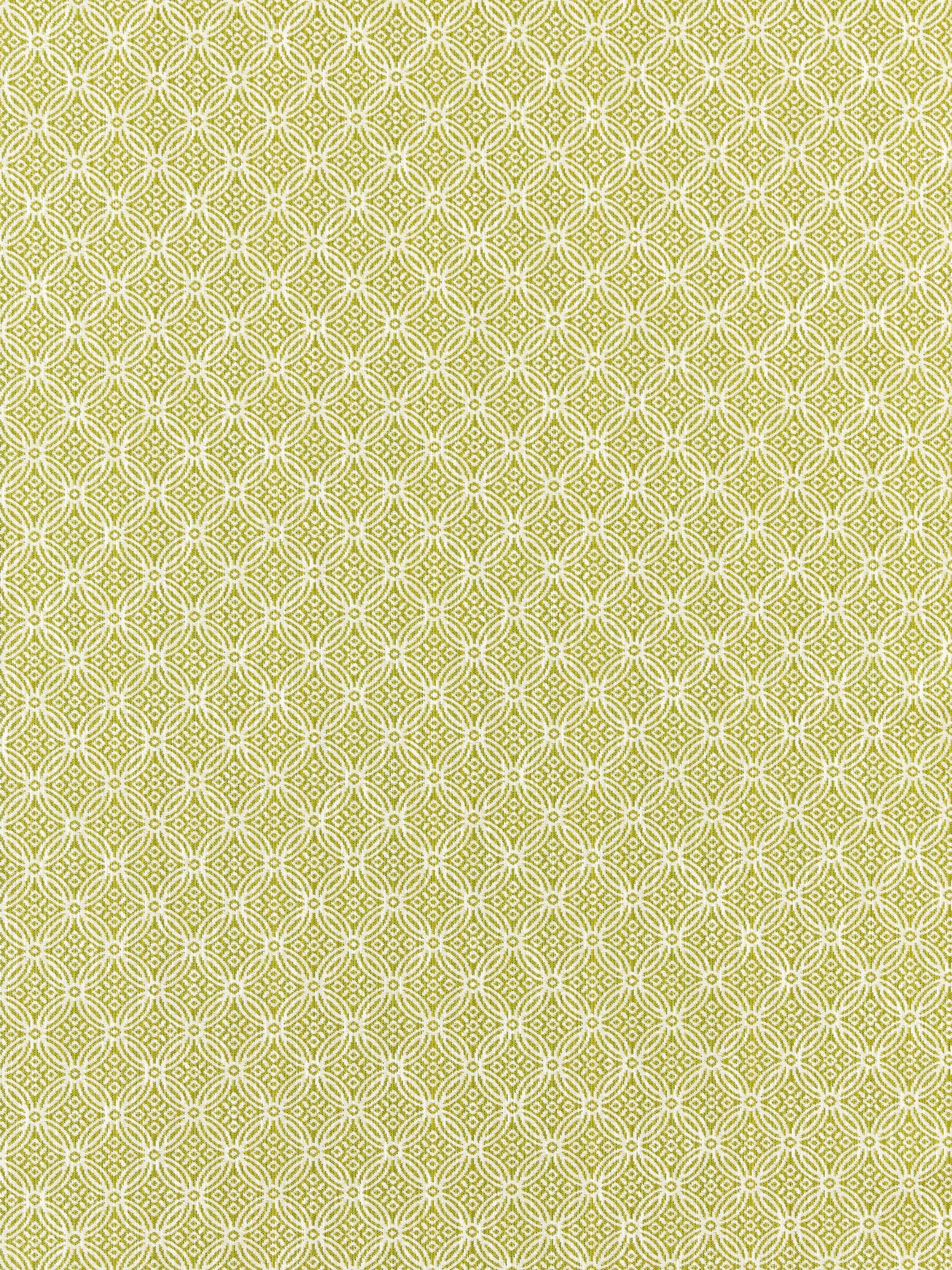 Key lime fabric with a white interlocking circle quatrefoil lattice pattern, repeating geometric textile design