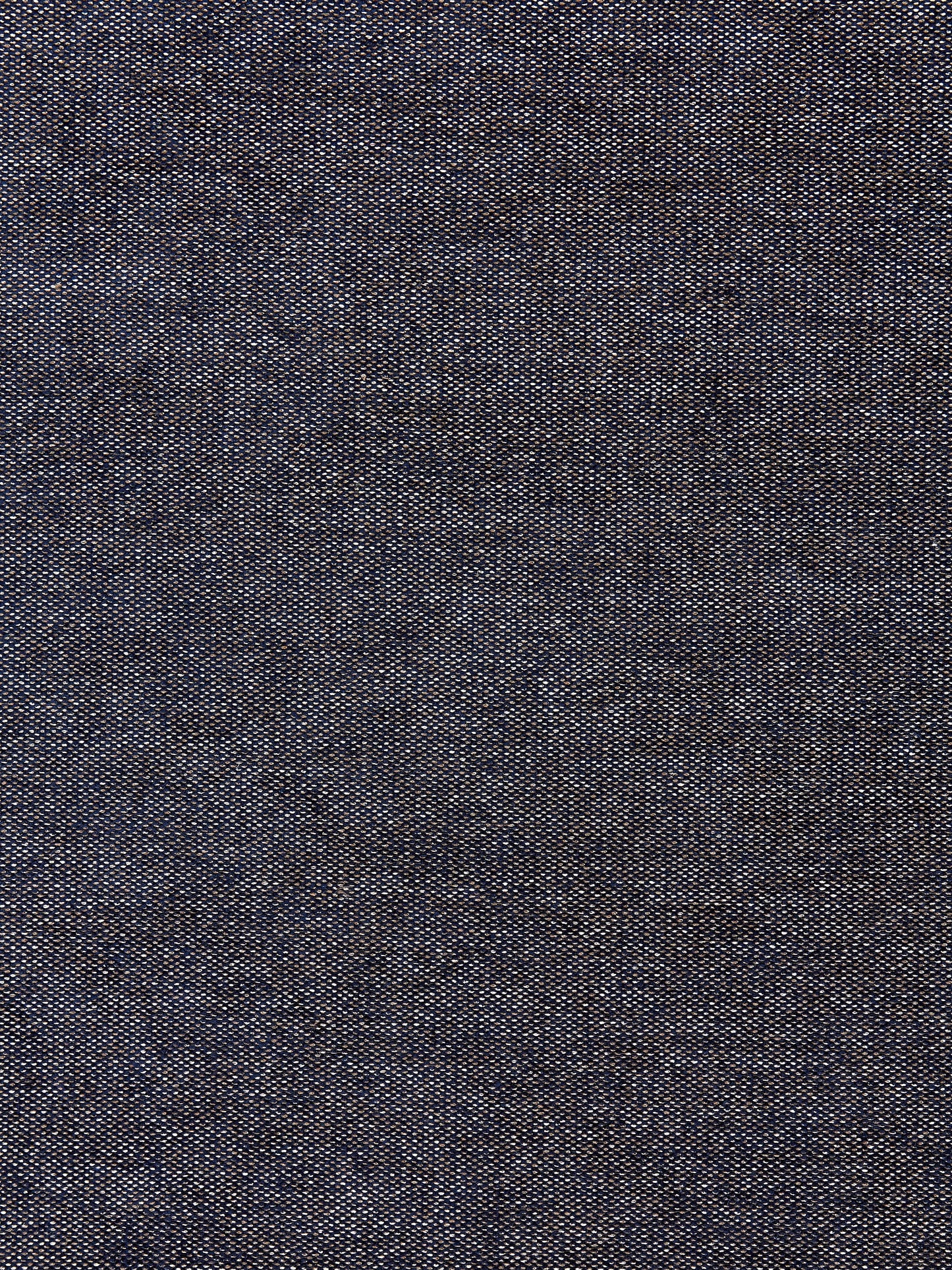 Close-up of dark indigo denim fabric with a subtle twill weave and light specks.