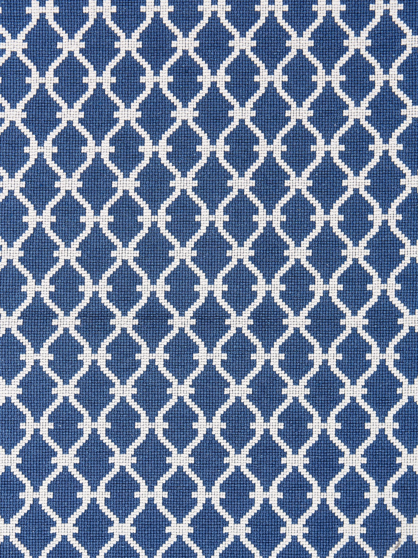Blue denim trellis-weave fabric with white interlocking lattice pattern.