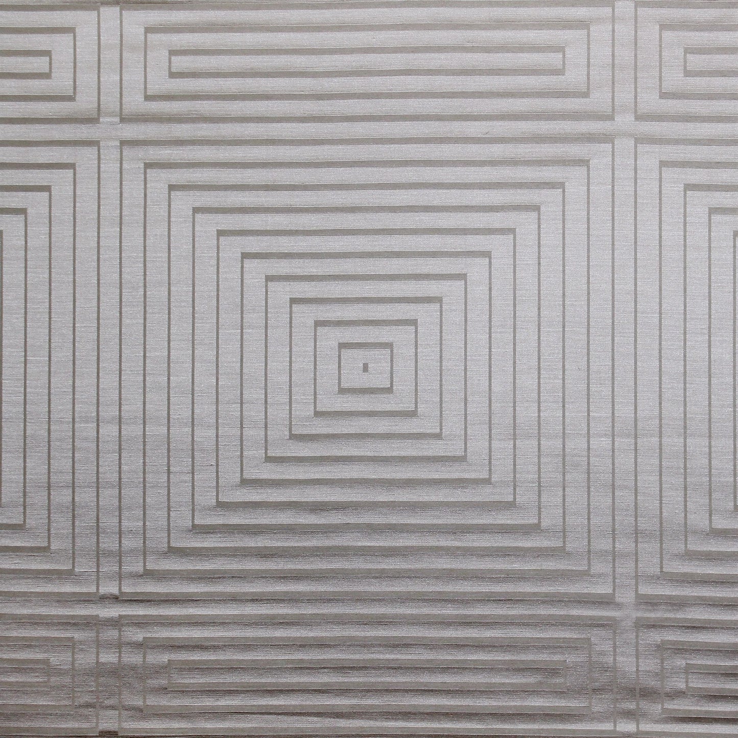 Taupe fabric with a subtle embossed geometric pattern.