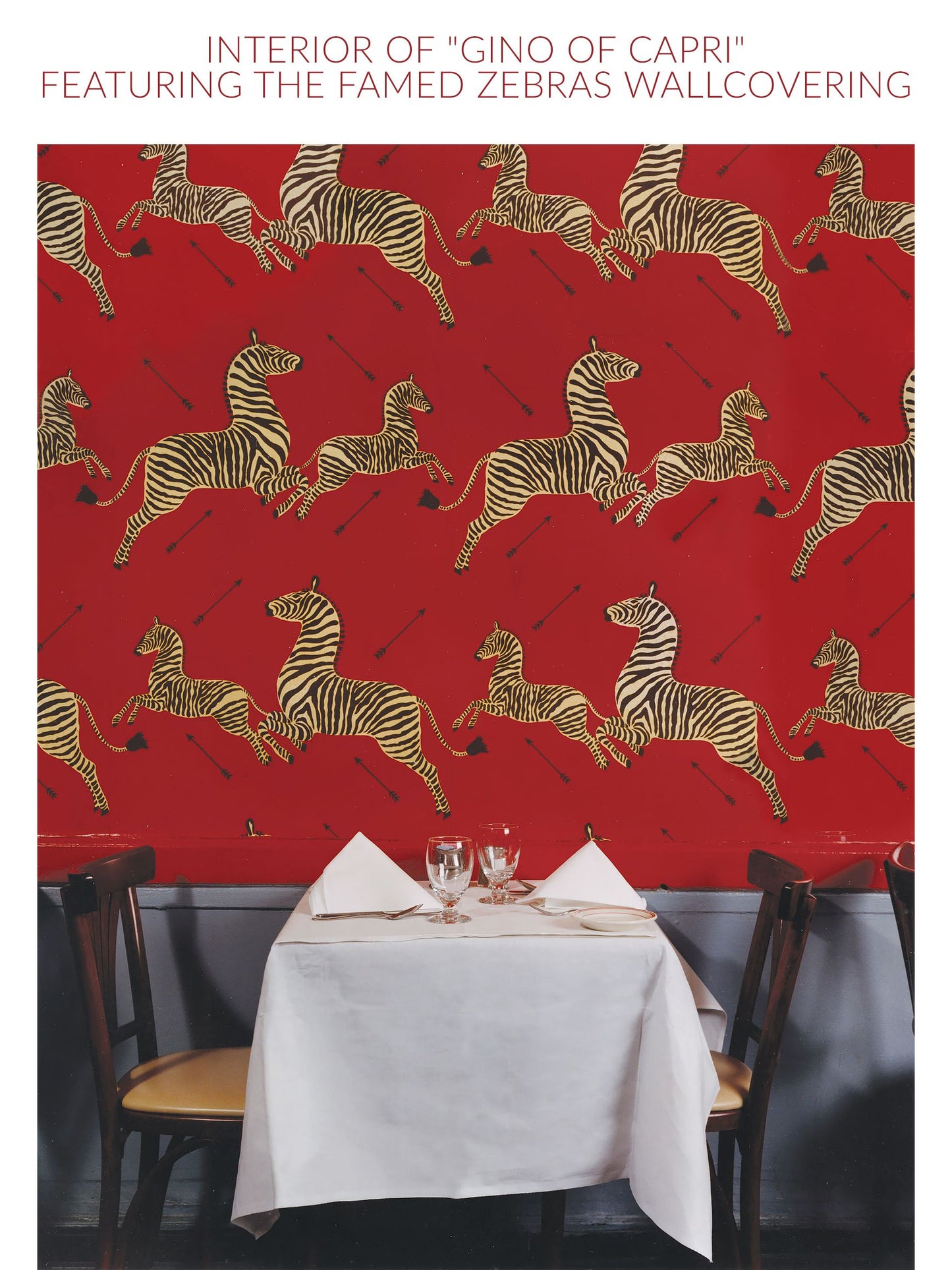 Red wall with a repeating zebra wallpaper pattern.