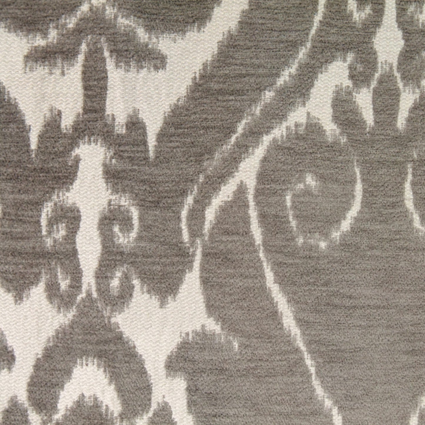 Taupe chenille fabric with a beige woven pattern and textured surface; ornate floral-scroll motif suitable for upholstery or rug.