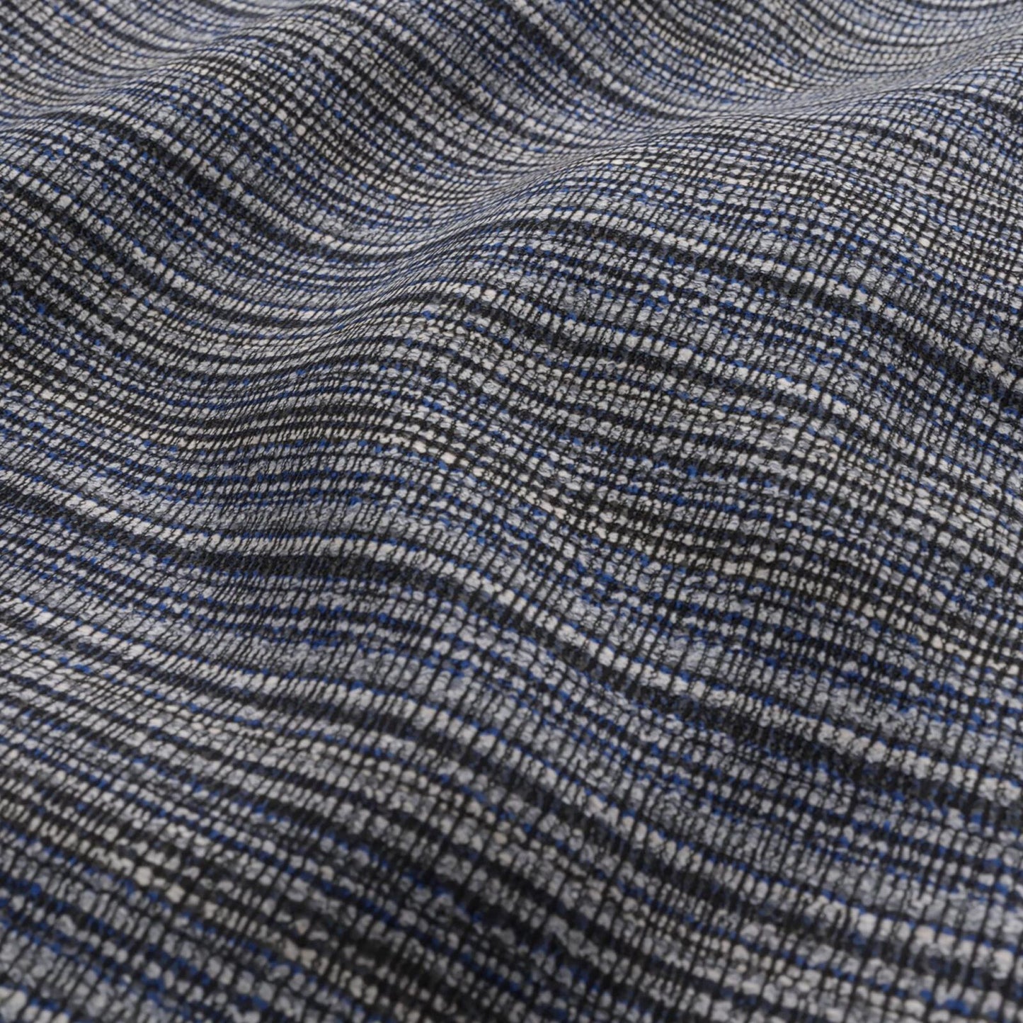 Close-up of navy, black, grey and white boucle outdoor fabric with a micro-check texture and soft drape.
