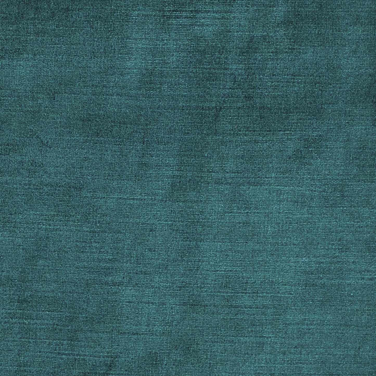 Teal textured fabric close-up with a velvet-like weave and subtle sheen.