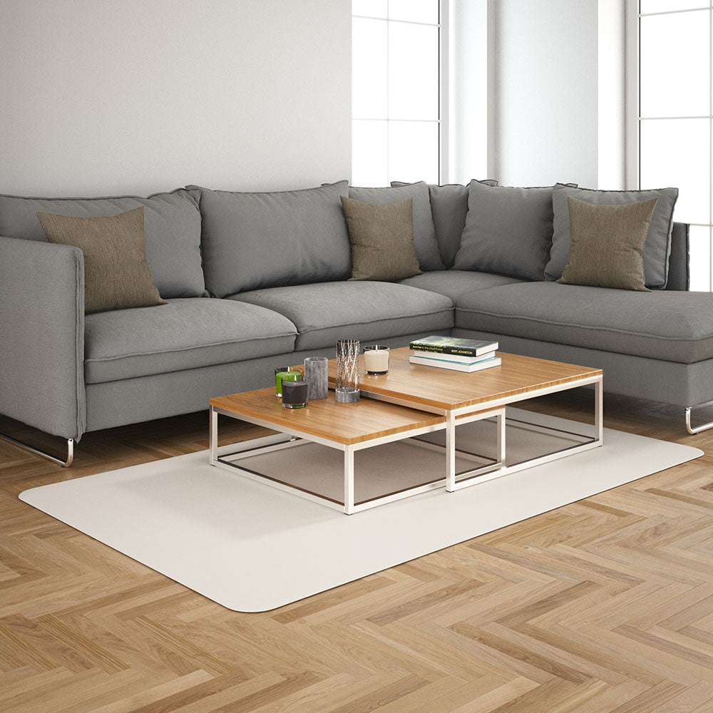 Mocha solid fabric sectional sofa in a modern living room with brown and gray cushions, two-tier wooden coffee tables on a light rug.