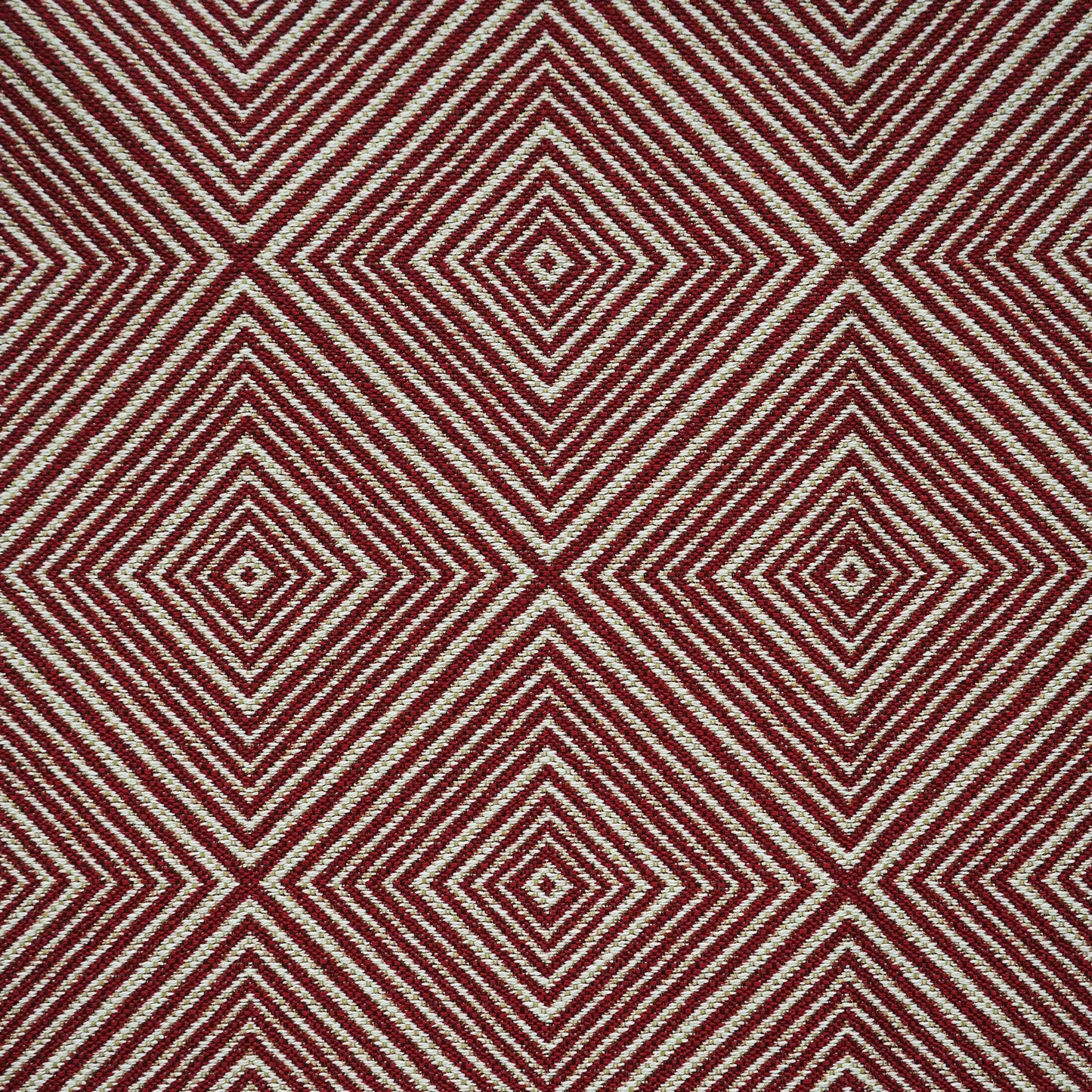Red and cream woven textile with a bold concentric diamond geometric pattern, retro rug-style fabric.