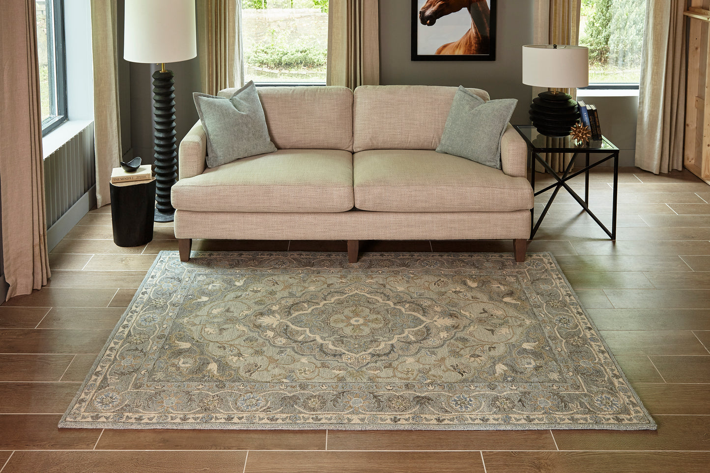 Blue-gray ornate area rug with a central medallion in a modern living room.