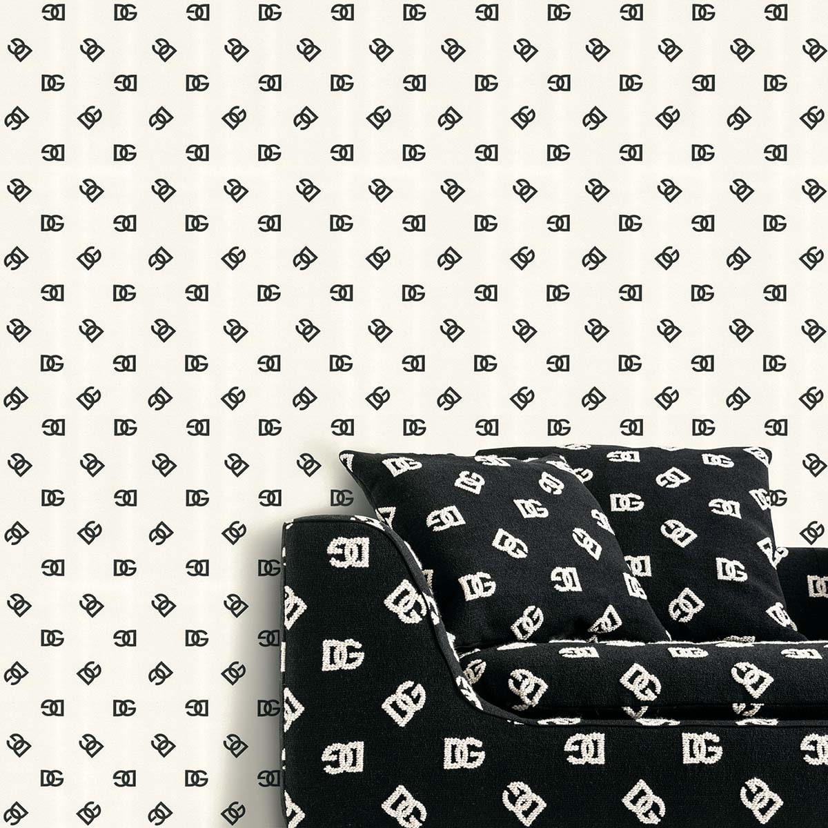 Black sofa with white monogram print cushions and matching wallpaper in a modern living room.