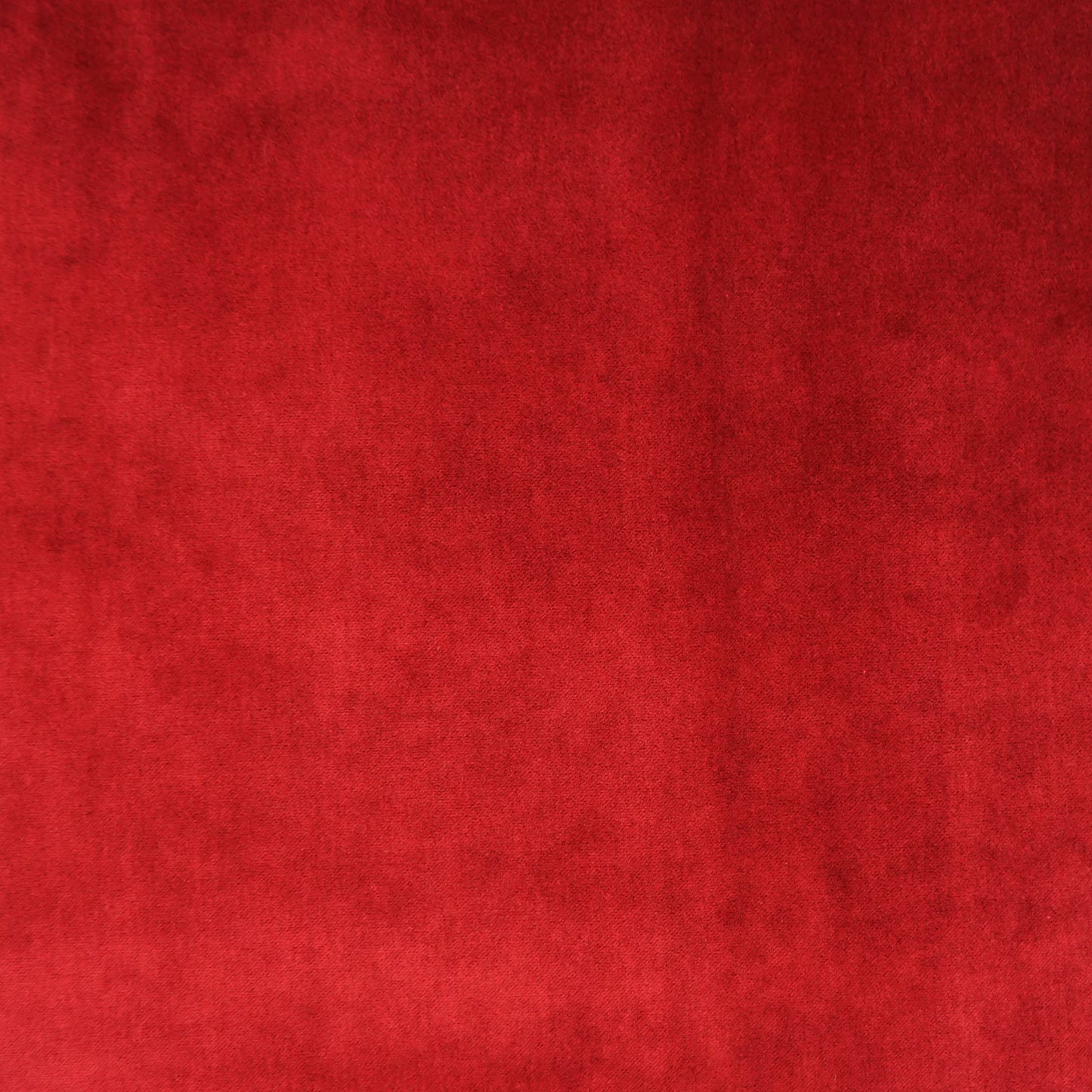 Deep burgundy velvet fabric texture with plush, luxurious look for upholstery or garments.