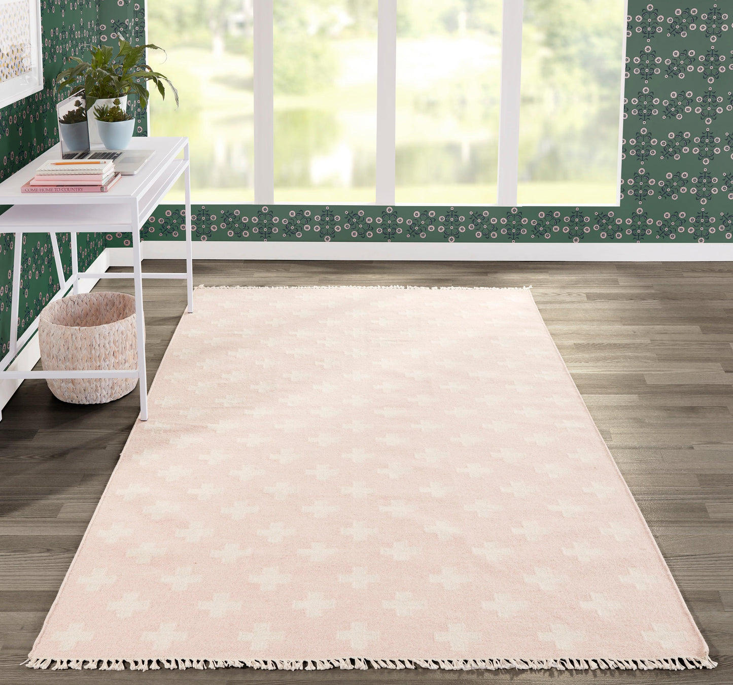 Soft pink rectangular rug with fringe tassels, ideal for cozy living room decor.