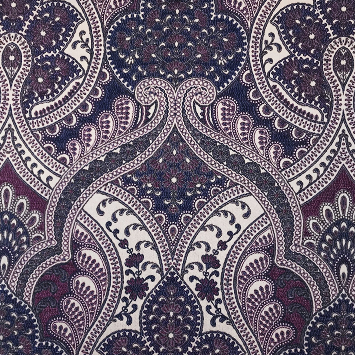 Intricate paisley jacquard fabric pattern in blue and purple with subtle texture for fashion or home decor.