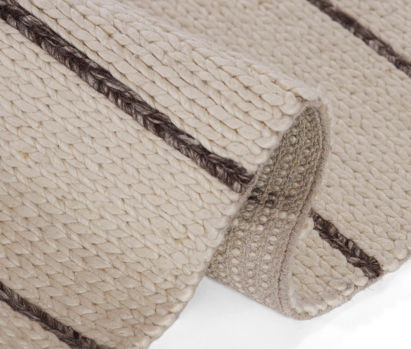 Cream chunky woven rug with a dark brown stripe, thick braided texture.