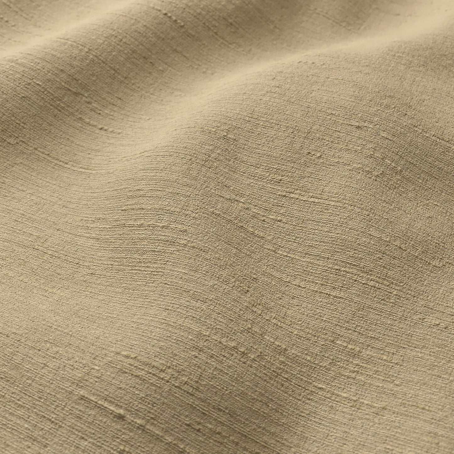 Beige-tan crepe fabric close-up with soft drape and strie texture.