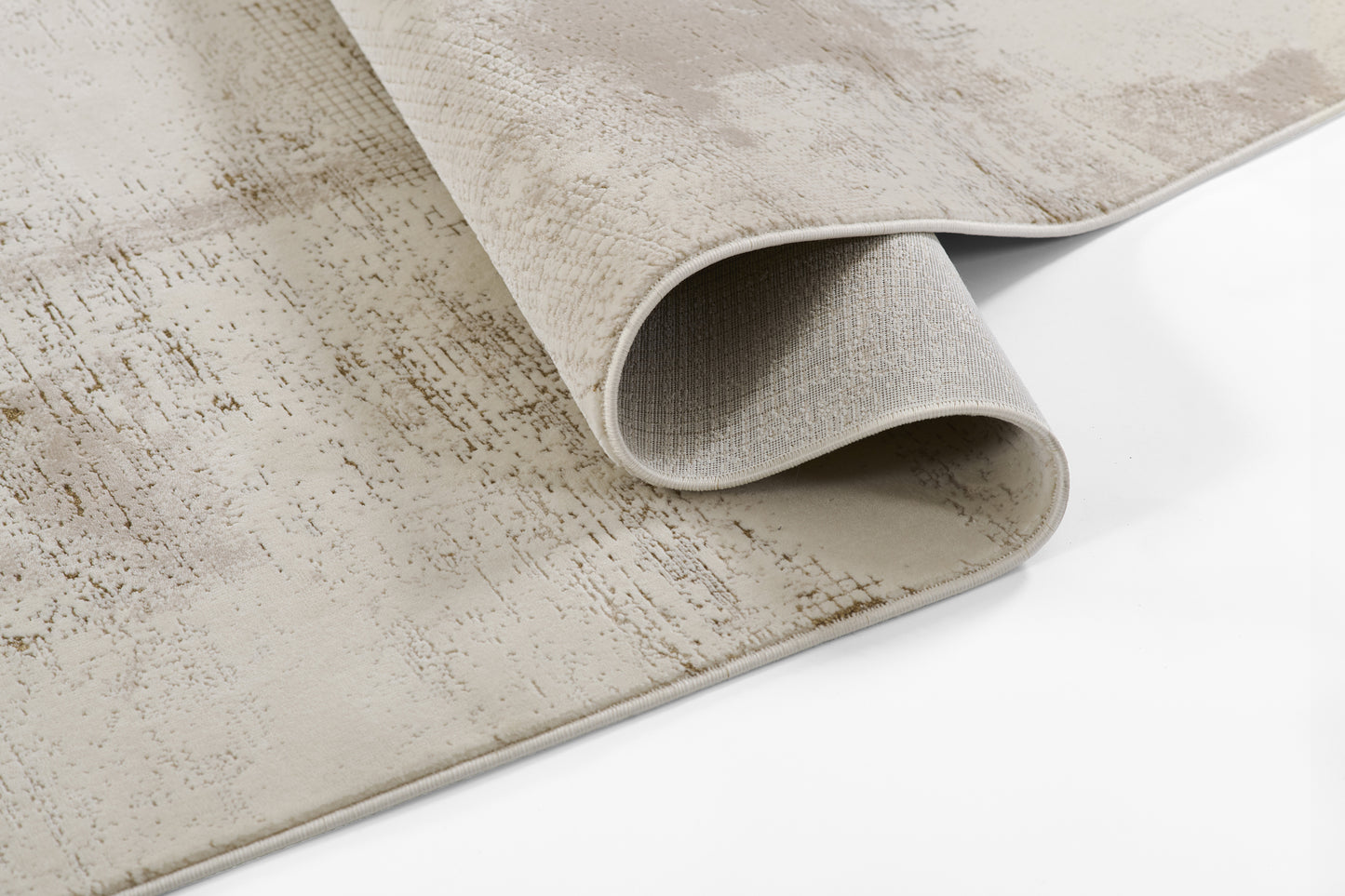 Beige distressed rug with subtle taupe pattern; rolled edge reveals light grey backing.