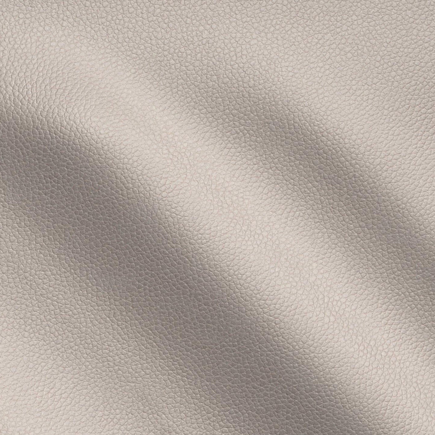 Brown pebbled vegan leather texture close-up with soft creases, leather-look vinyl fabric.