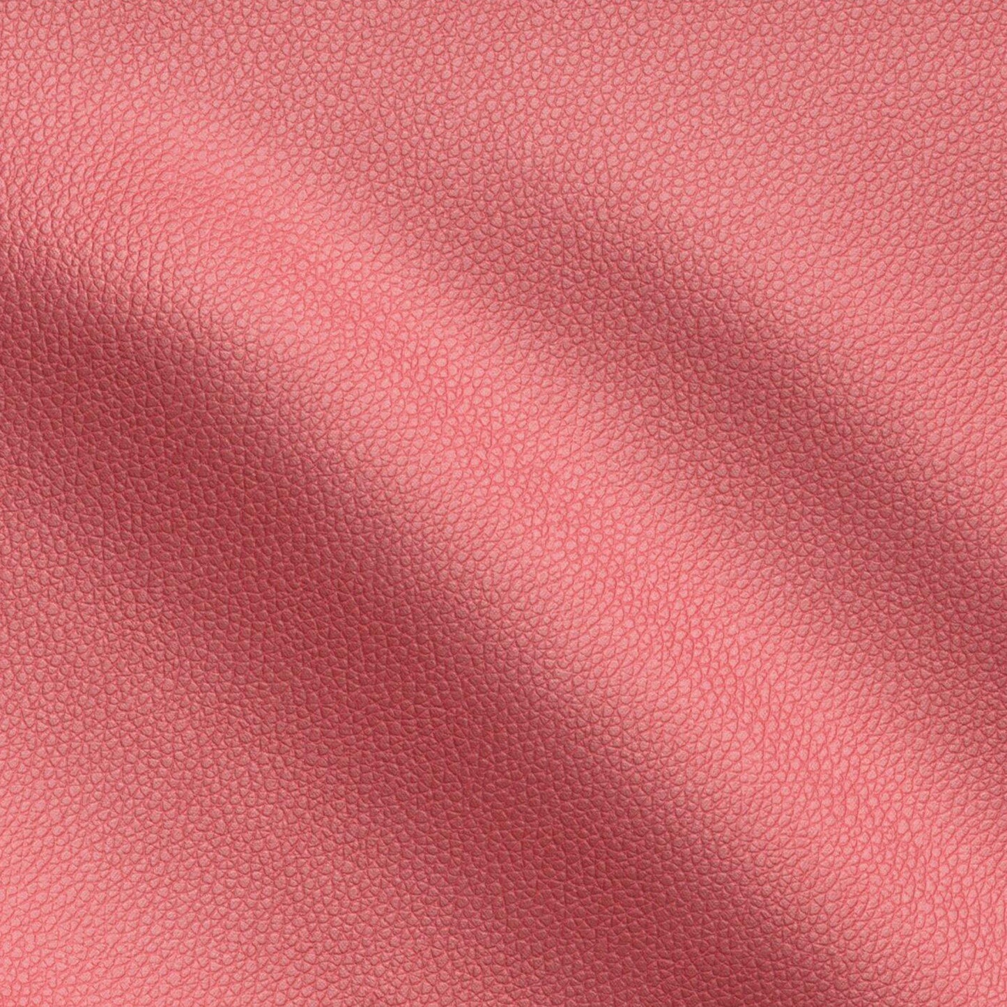 Red pebbled vegan leather texture close-up with soft folds.