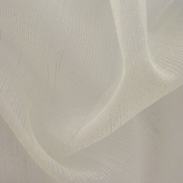 Cream sheer fabric with subtle metallic threads and soft drape, light, delicate, ideal for overlays or curtains.