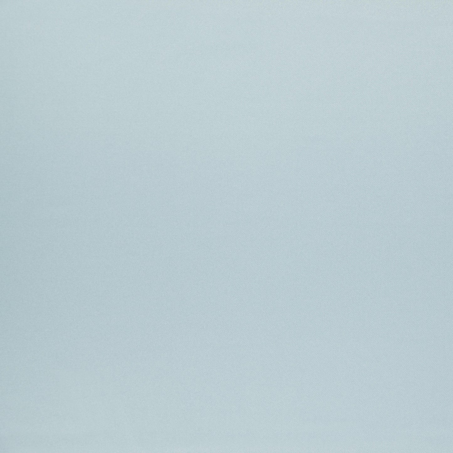 Soft pale blue fabric backdrop with subtle texture.