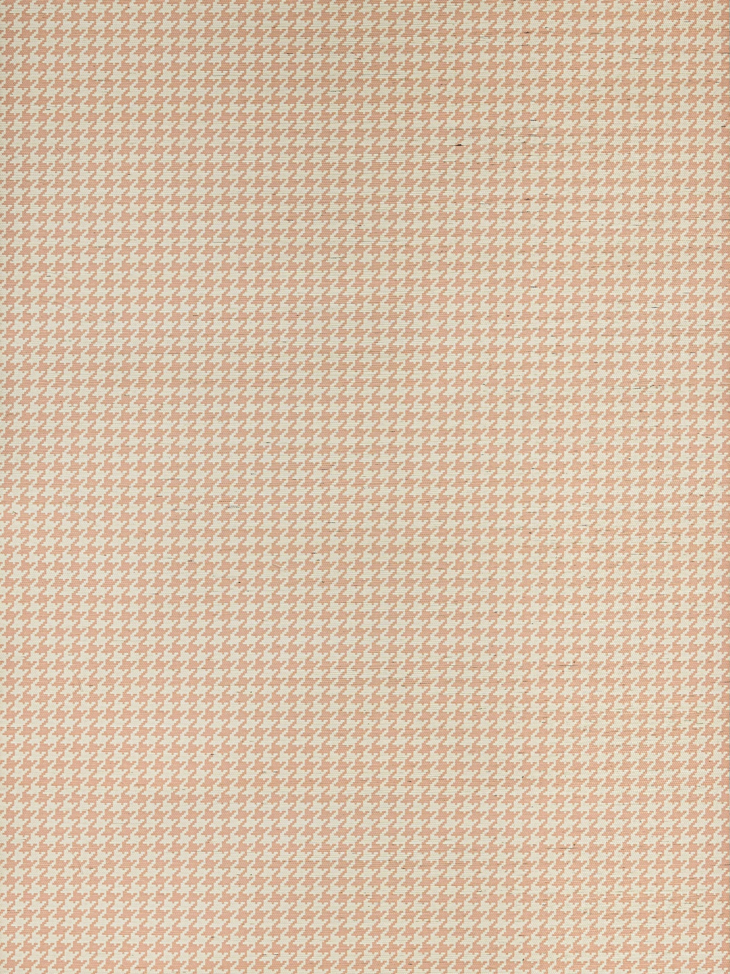 Peach and cream houndstooth fabric swatch with small repeating pattern, woven textile suitable for garments or upholstery.