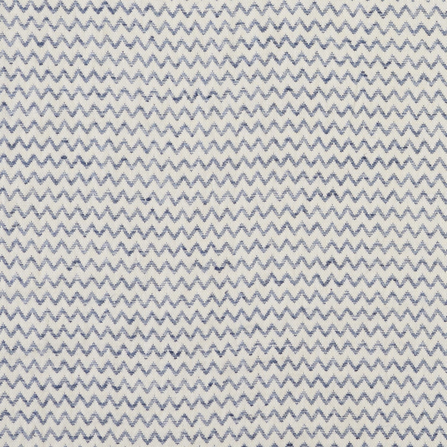 White fabric with blue zigzag chevron pattern; lightweight woven textile for apparel or decor.