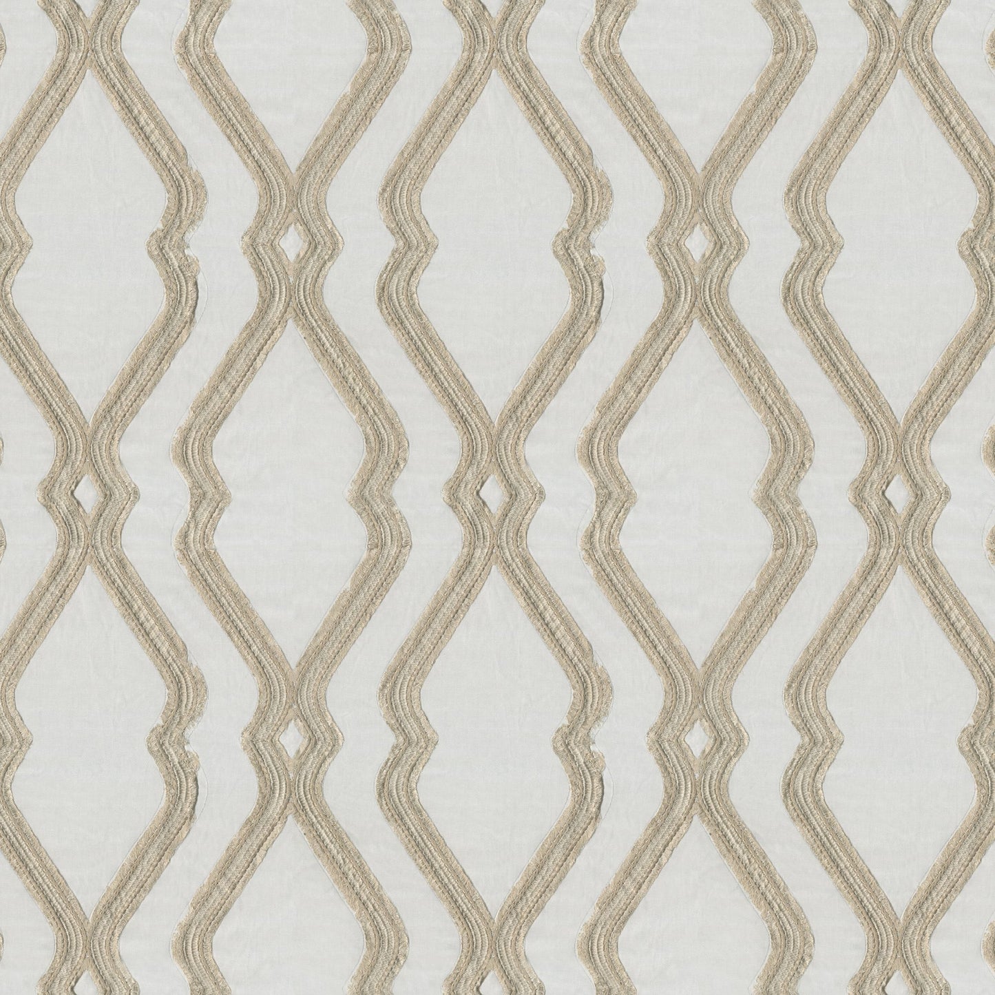 Beige ogee embroidery on pale gray textured fabric.
