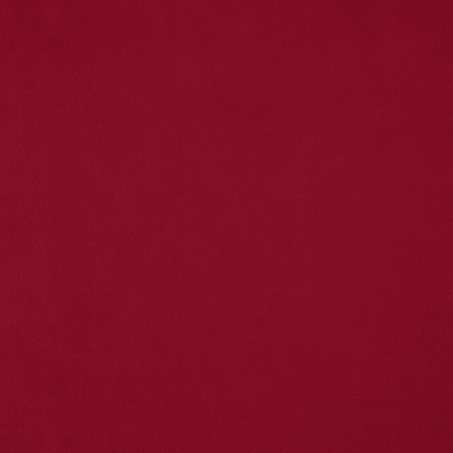 Solid deep red faux suede fabric with a soft textured nap, versatile for upholstery or fashion.
