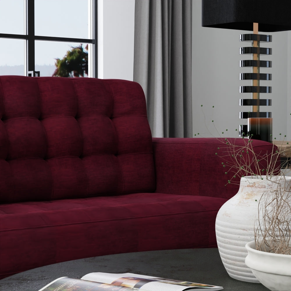 Cranberry solid fabric upholstery in a modern living room with a black striped lamp, white ceramic vase, and gray curtains.