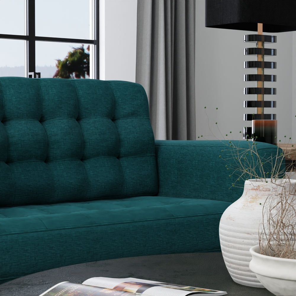 Teal Juniper solid fabric upholstery in a modern living room setting, shown on furniture with a large window, gray curtains, & black lamp, and white vase.
