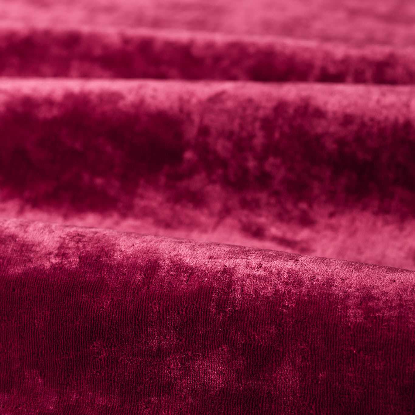 Rich burgundy velvet fabric close-up with soft plush pile and elegant drape.