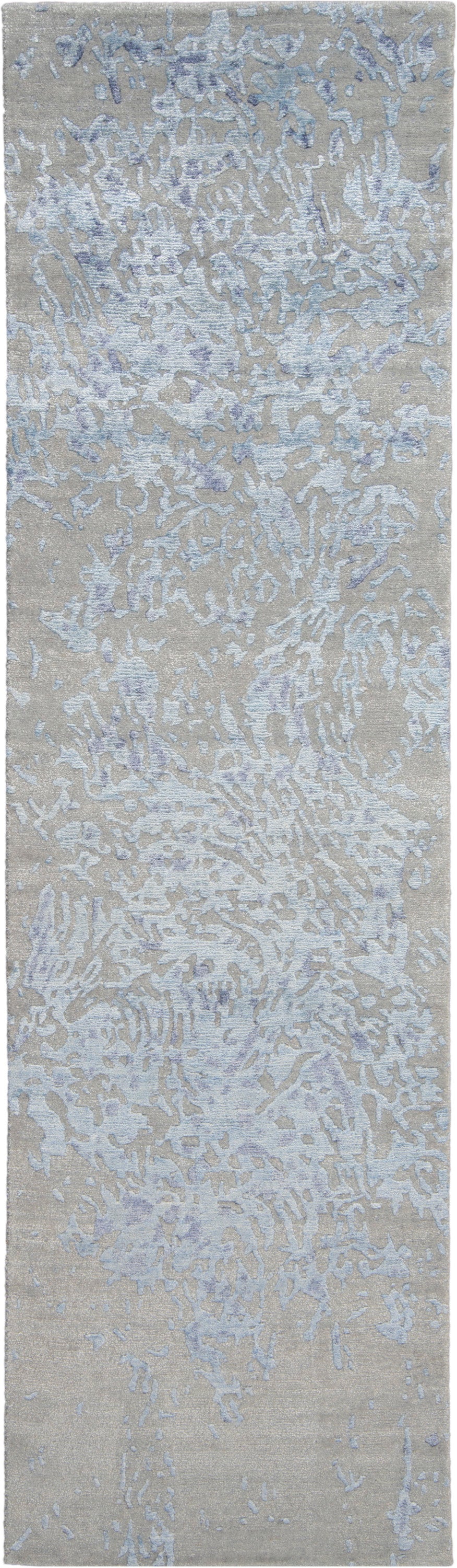 Beige abstract area rug with pale blue and lavender irregular motif; modern textured design.