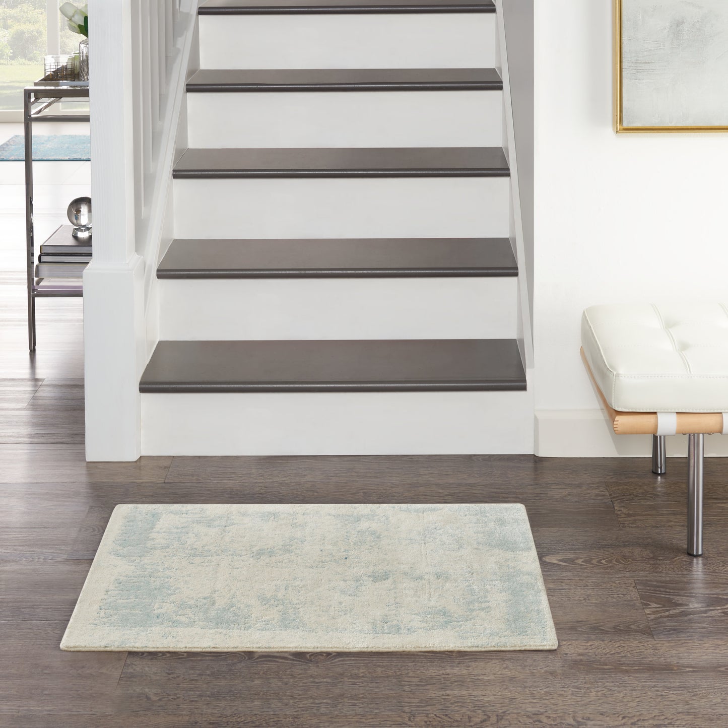 Light blue 2' x 3' rug on dark wood floor in a modern interior.