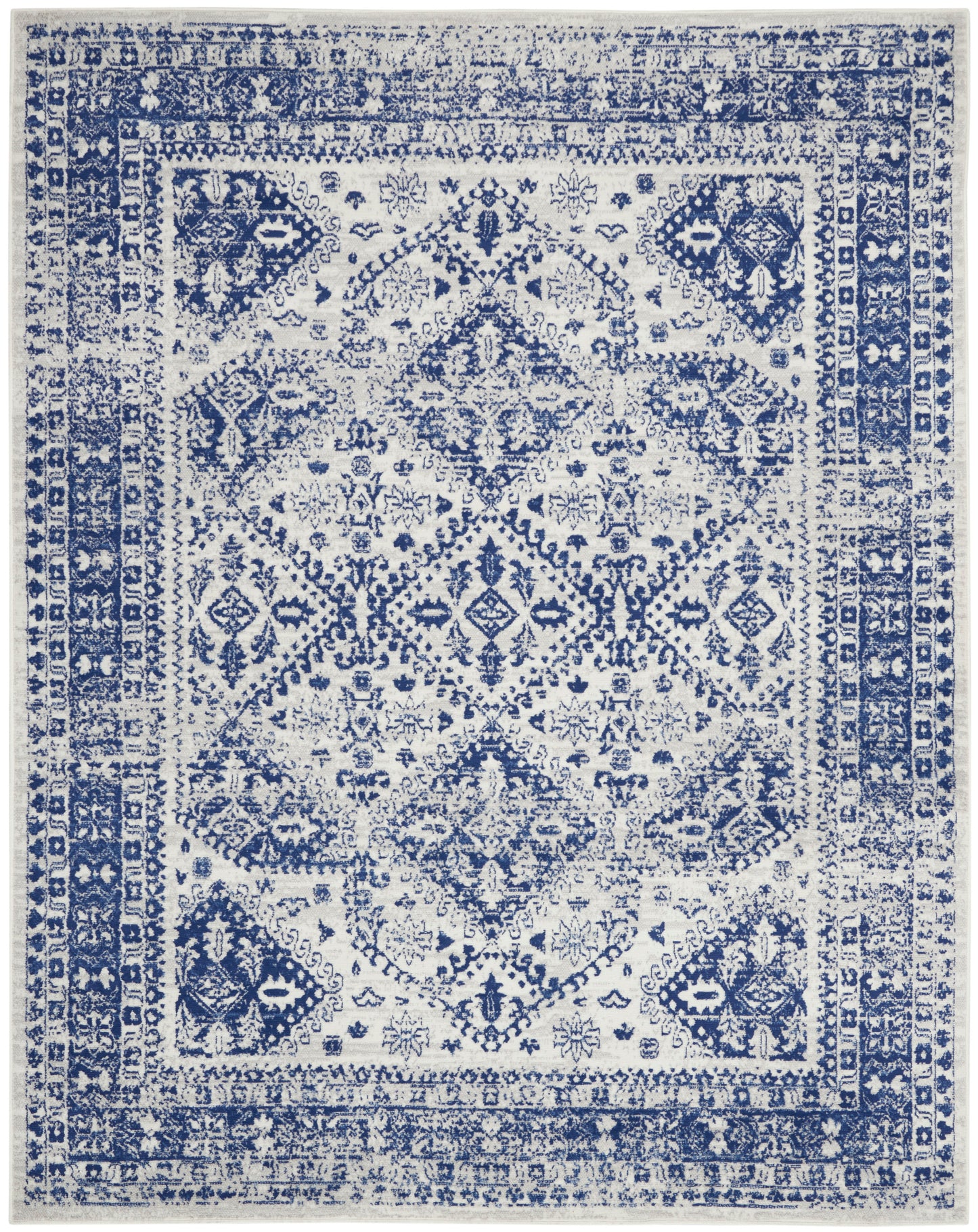 Blue and white Persian-style area rug with distressed floral-diamond central motif and decorative border, rectangular.