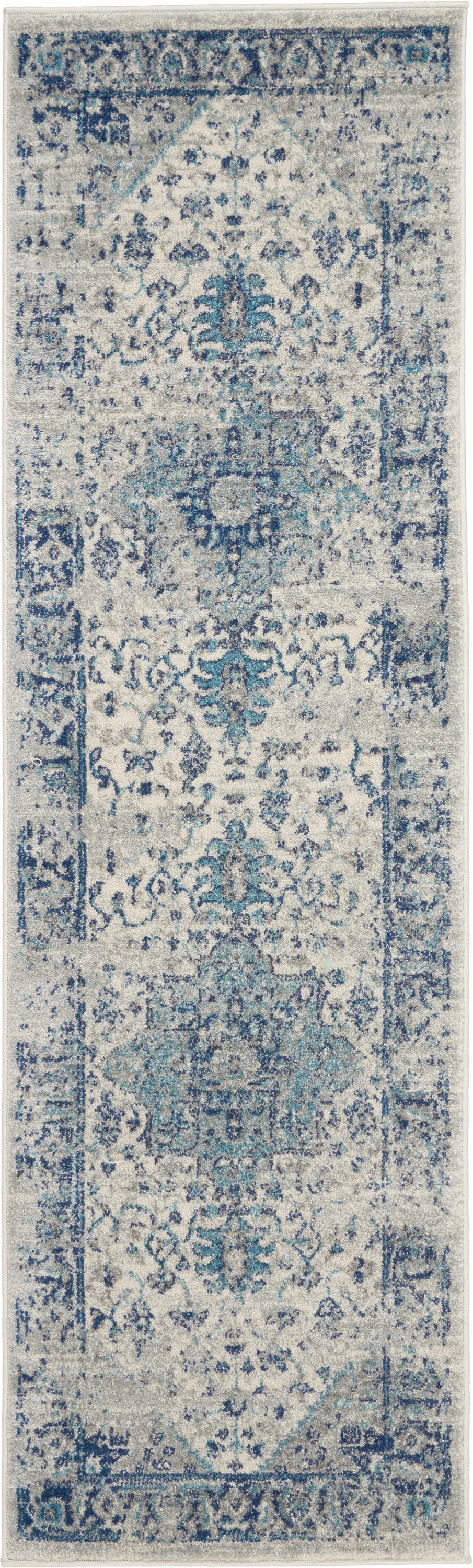 Blue & ivory distressed Persian-style runner rug with intricate floral motifs and vintage look.